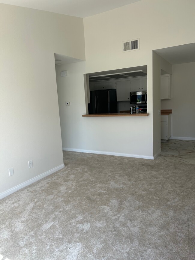 Living Area (view into kitchen) - 9419 Fairgrove Ln Condo Unit 202