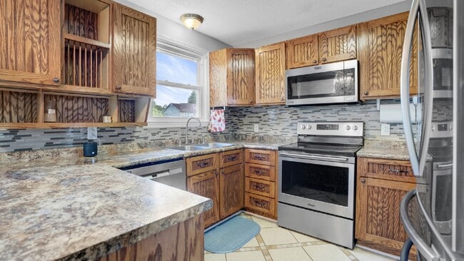 Photo - For Rent : 4BR, 1 1/2BA home with fenced in back yard and storage building.