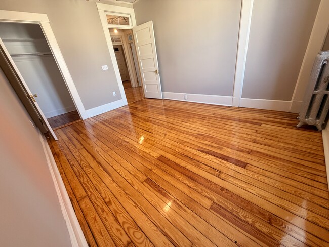 large bedroom with hardwood floors - 69 S Pleasant St