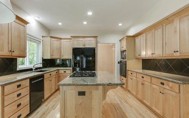 Photo - Spacious Four-Bedroom Home with Gourmet Kitchen, Multiple Living Areas, Loft, and Beautifully Lan...