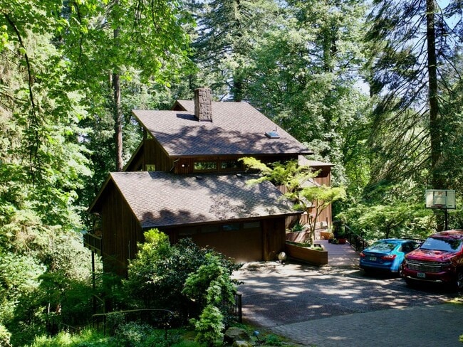 Building Photo - One-of-a-Kind Custom Home with Wall of Windows, Stone Fireplaces, Expansive Entertainment Space &...