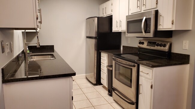 Kitchen with granite countertops and stainless steel appliances - 1650 Cedarwood Dr Unit 1650 Cedarwood dr