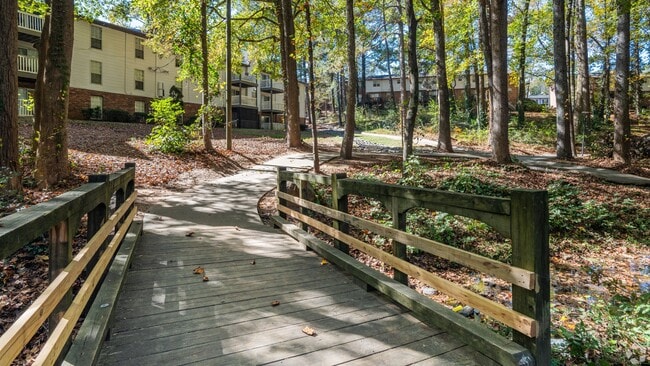 Explore the scenic walking trail perfect for a peaceful nature walk or a morning jog in the tranquility of the wooded surroundings. - Legacy at West Cobb Townhomes