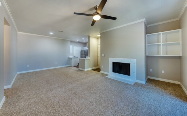 Seen empty, the room shows its full depth from the entry to the kitchen bar.