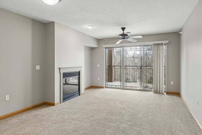 Expansive windows, a cozy fireplace, and a private balcony create a bright living space made for relaxing year round.