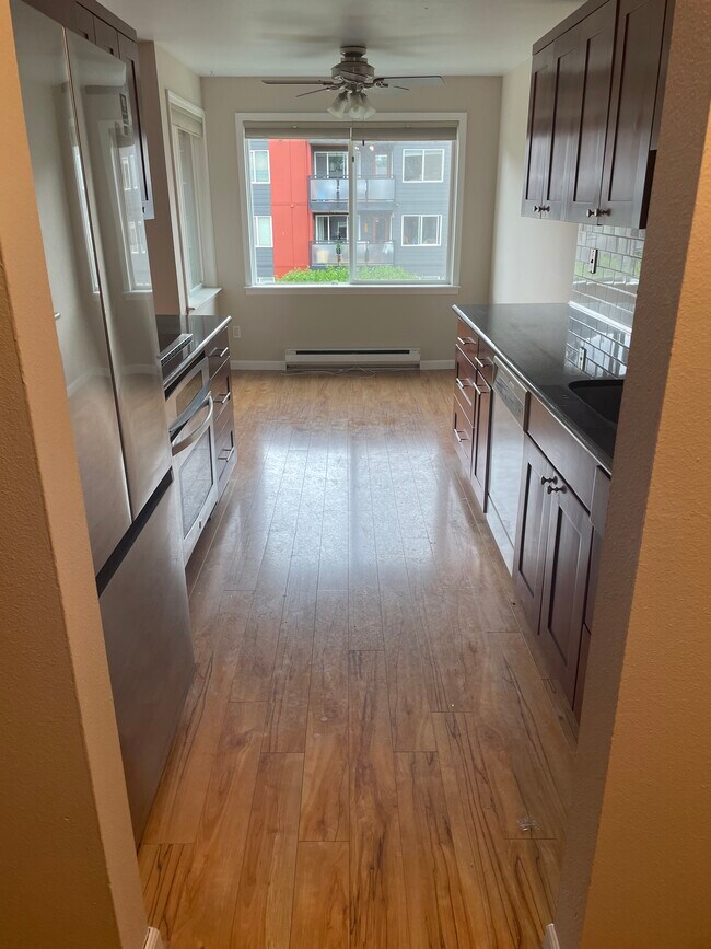 Kitchen with granite countertops and higher end applicances - 7001 Sand Point Way NE Unit A0001
