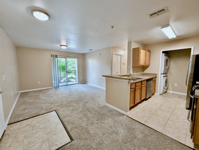 Bright and spacious apartment with an open-concept living area, modern kitchen, and large windows leading to a serene balcony view.