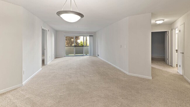 Carpeted Living Room with Balcony