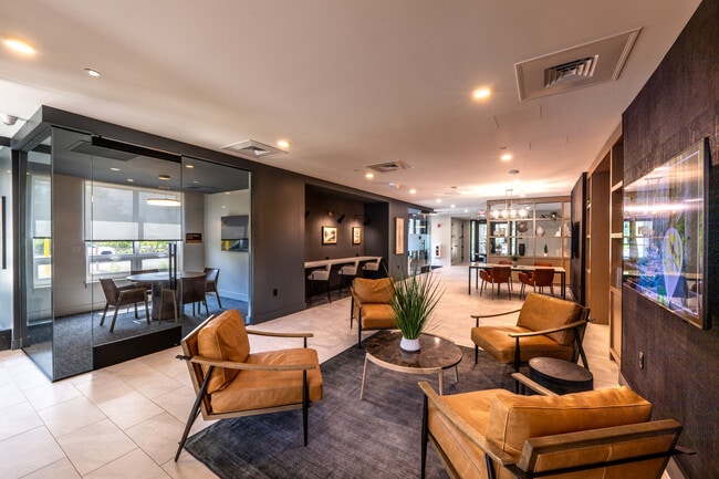Resident clubhouse lounge featuring contemporary furnishings, fireplace seating, and upscale communi