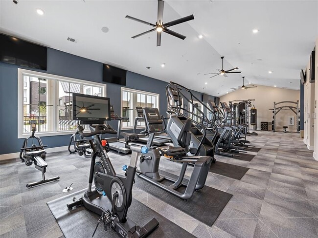 with a variety of exercise equipment including treadmills, stationary bikes, and weight machines