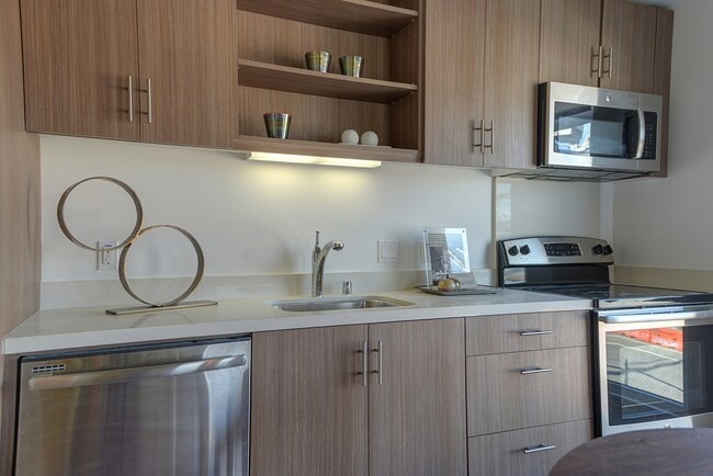 Stylish kitchen with stainless steel appliances and quartz countertops
