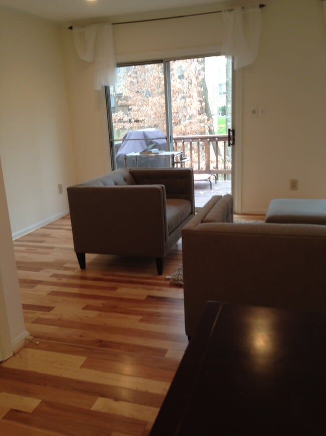 Open floor plan, with kitchen open to dining and living rooms, view onto deck and woods - 10651 Pine Haven Ter