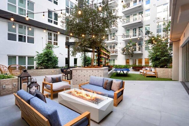 Gather around a firepit under sparkling string lighting in one of two stunning courtyards at Modera San Diego