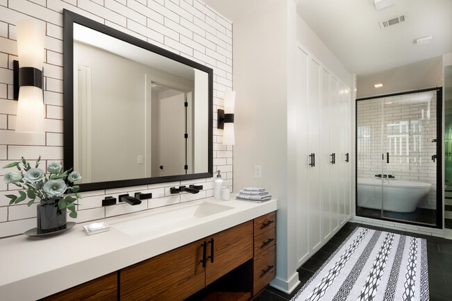 Bath with wood cabinetry, white quartz countertops, tile flooring, and extra storage