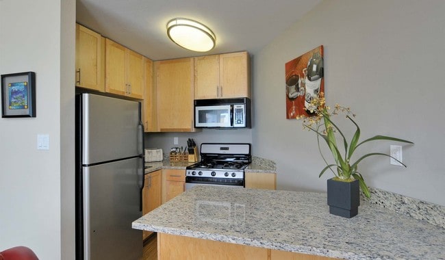 Bright and open kitchen with granite countertops and breakfast bar