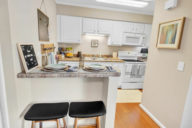 Enjoy a modern kitchen with a convenient breakfast bar and full appliance package at Eagles West Apartments.