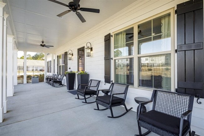 Clubhouse exterior porch with rocking chairs to relax and unwind.