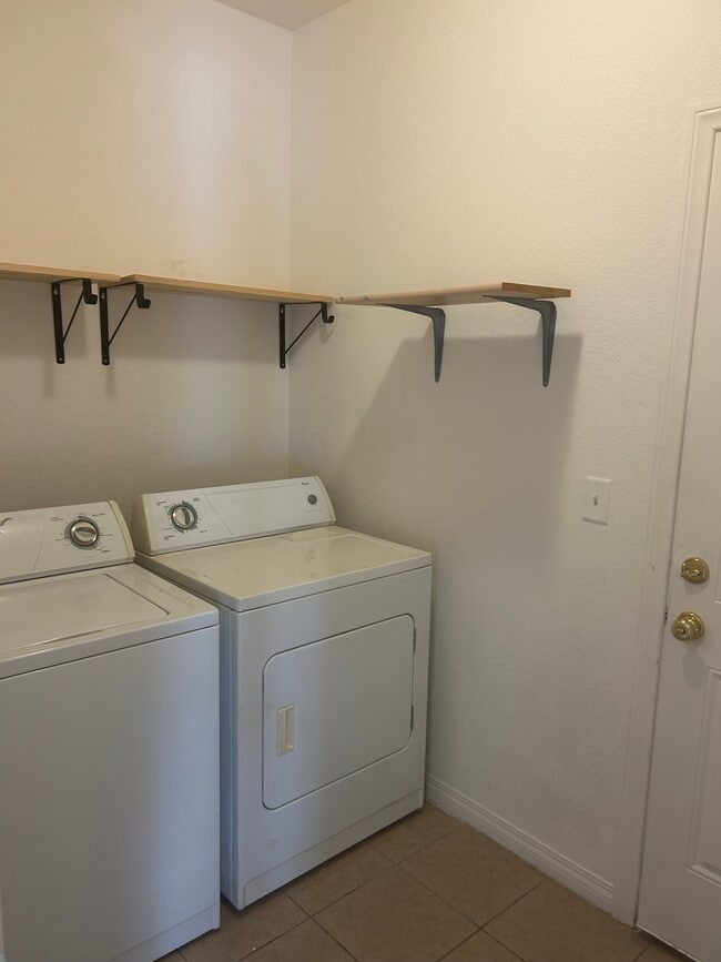 Washer and dryer in laundry room - 10730 Garibaldi Dr Unidad A