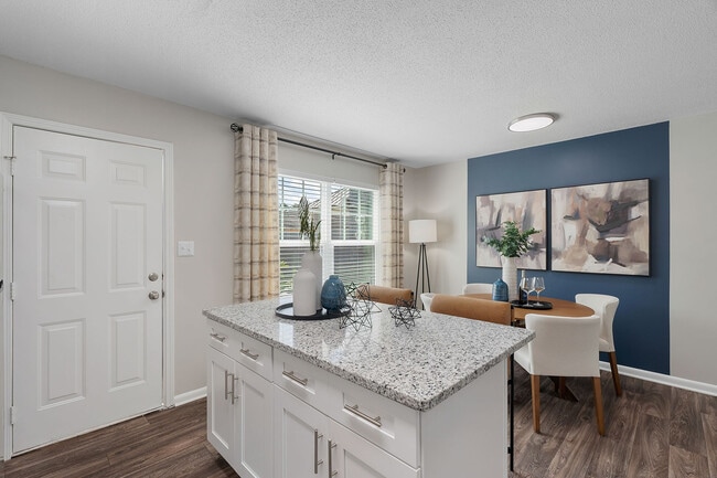 Kitchen Island with granite counters and hardwood style flooring
