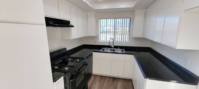 Cocina con abundante luz natural y armario en Northwood Apartments en Upland, California.