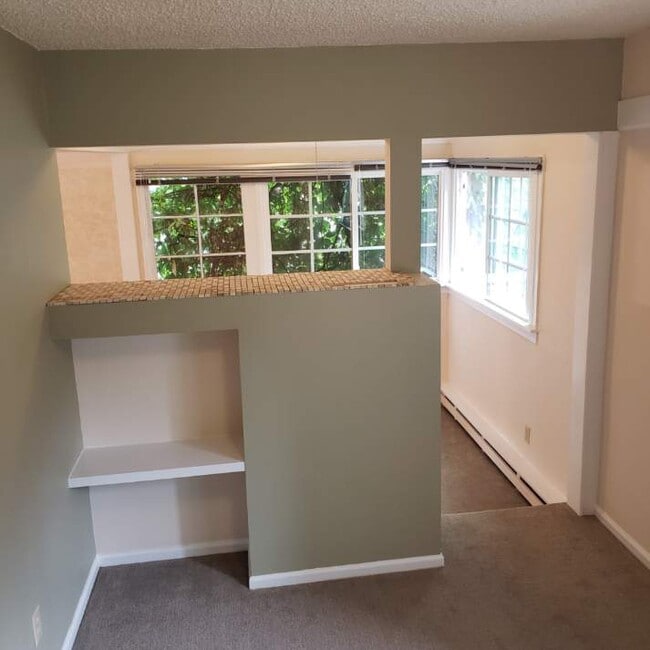 bedroom with built-ins and tile top between livingroom