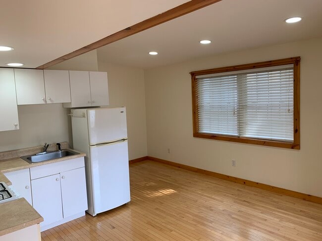Looking from bedroom doorway into open-concept kitchen/living room area - 37 Court St Unit Apt. C