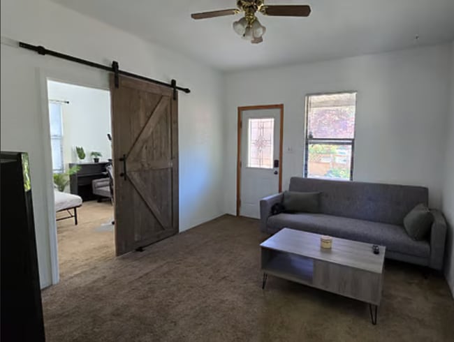Living Room with Ceiling Fan, A/C, Rustic Barn Door to 2nd Bedroom / Office, Sofa Bed