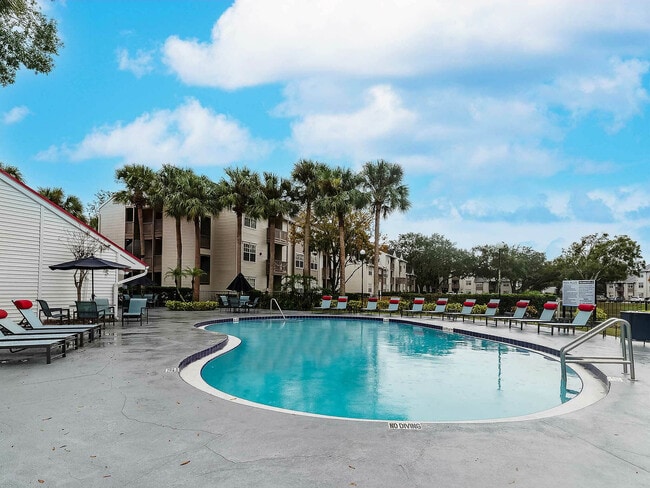 Experience serene poolside living with lush tropical scenery.