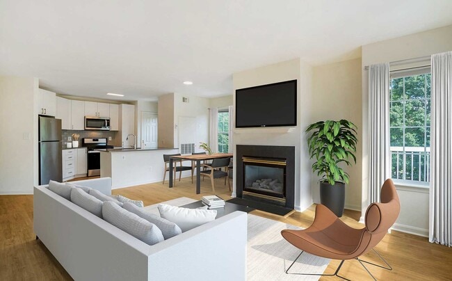 Renovated Package IV kitchen, living, and dining areas with hard surface plank flooring