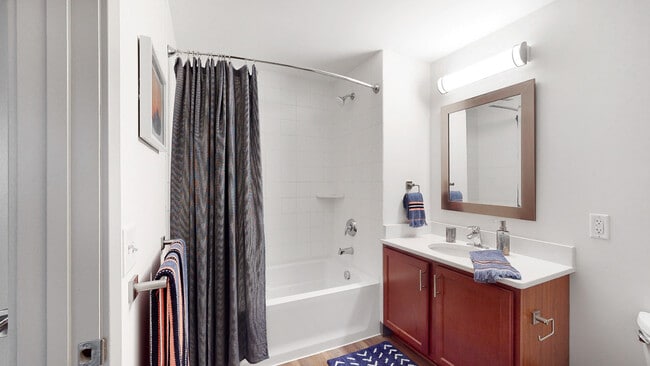 Our bathrooms feature a clean and modern design with a full-size tub and shower, perfect for relaxing and refreshing.