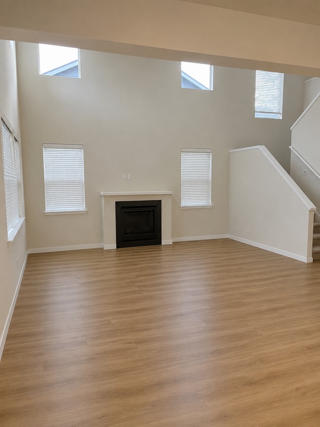 Main living area with gas fireplace and remote control upper window shades - 8002 116th Street Ct SW