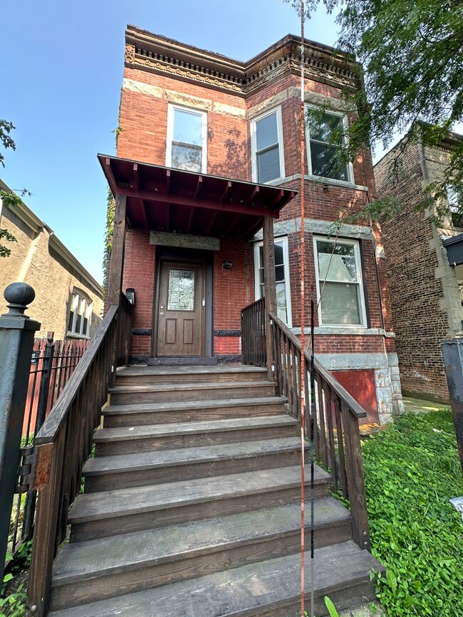 Front stairway leading up to the private entrance of this fully renovated first-floor unit - 5653 S May St Unit 1