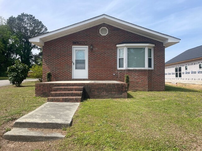 Building Photo - Brick Ranch- Dunn- 4 bedroom 2.5 bath- 2 car carport- Corner Lot