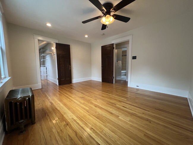 Large master bedroom with walk-in closet, ceiling fan and recessed lights. - 61 Hirschfield Dr Unit Upper