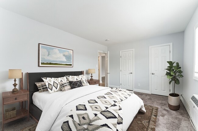 Step into comfort at Mid Island Apartments. This spacious bedroom features modern decor, ample storage, and a serene atmosphere, perfect for relaxation. Elevate your living experience—schedule your visit today!