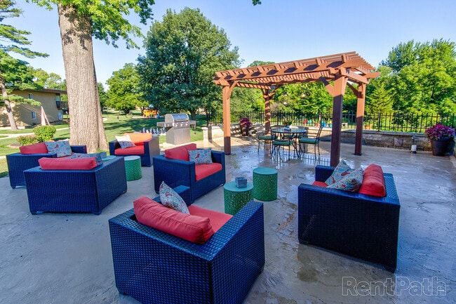 Inviting outdoor lounge area with patio furniture and pergola, perfect for gatherings and relaxation.