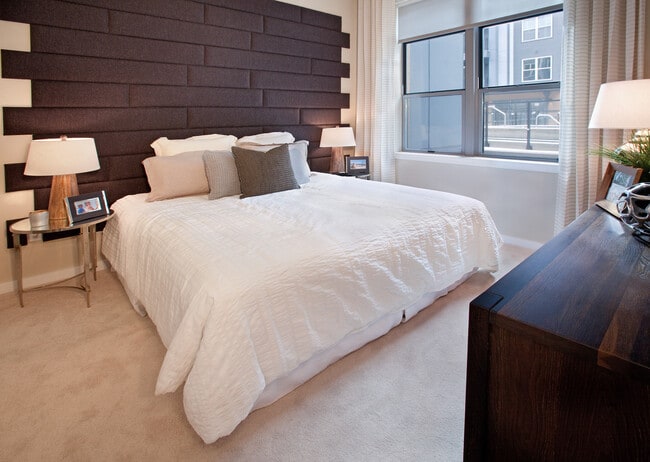 Bedroom with accent wall and carpet