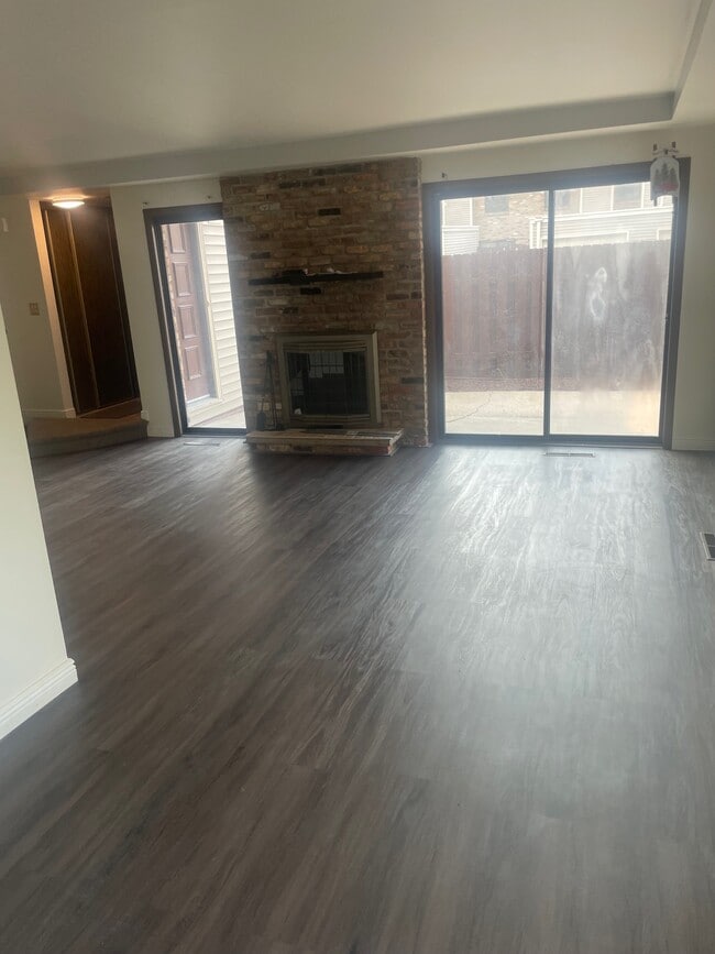 Living room with walkout patio and fireplace - 4733 Cedar Lake Rd S