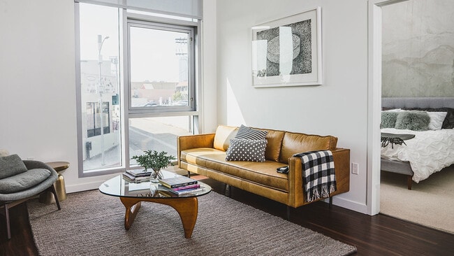 Bright lit open floor plans featuring sustainable hardwood flooring