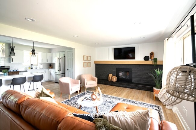 Open living room with electric fireplace - 7621 Central College Rd