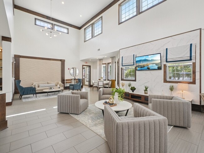 Bright and spacious resident clubhouse with modern lounge seating at Village at Broadstone Station in Apex, North Carolina