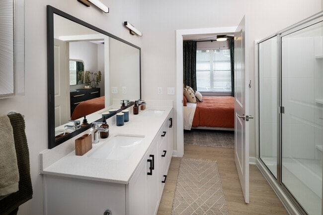 Bath with white shaker cabinetry, white quartz countertop, and hard-surface vinyl plank flooring