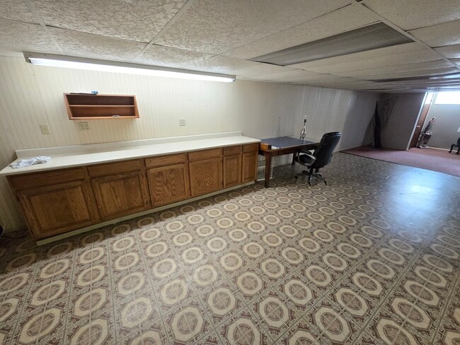 Mini kitchen for small fridge, microwave. Study area. - 6874 Joanne Cir N
