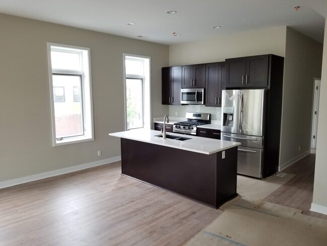 Kitchen with island and full suite of stainless steel appliances - 1548 119th St Unit 200