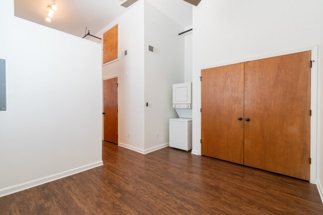 Loft style bedroom with large closet and washer/ dryer
