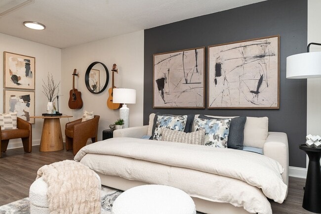 Spacious open living & sleeping area with hardwood-style flooring