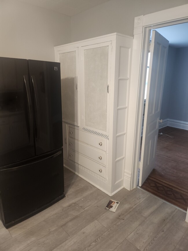 Kitchen newly panted, black refridgerator - 238 N Lockwood Ave