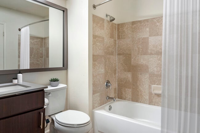 Renovated Package II bath with espresso cabinetry, grey quartz countertops, and hard surface plank flooring