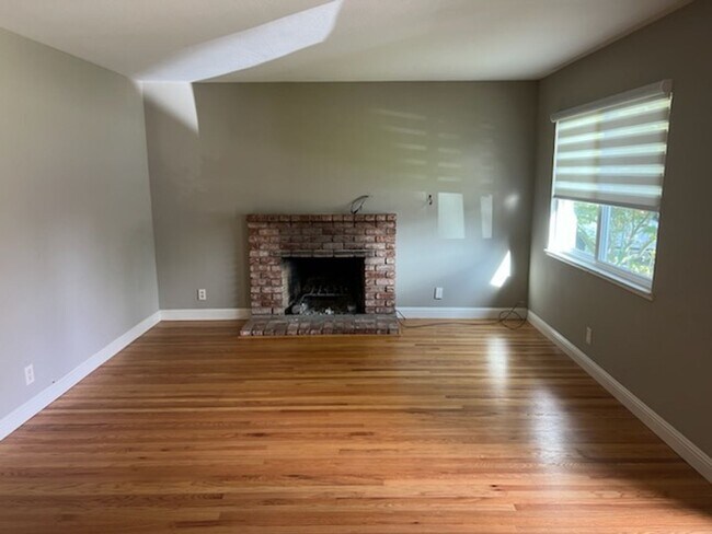 Photo - Beautiful updated home with all stainless steel appliances, hardwood floors throughout, and a lar...