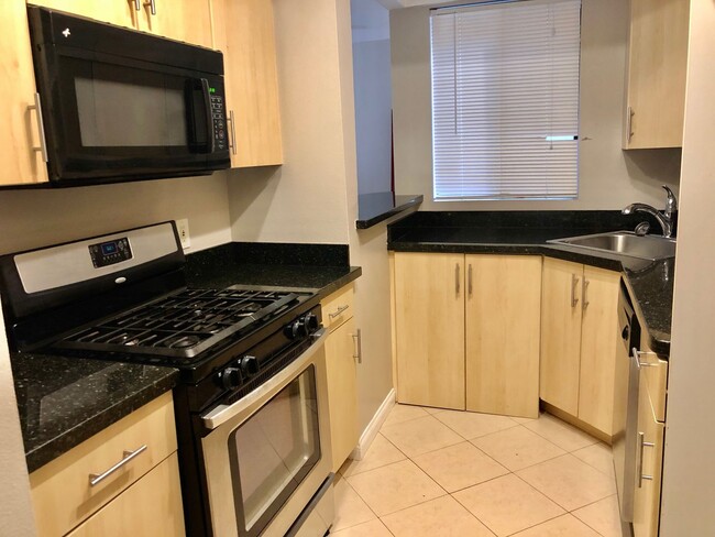 Building Photo - REMODELED CONDO WITH WOOD FLOORS! NEW KITCHEN! FIREPLACE! GYM, POOL! REC ROOM AND MORE